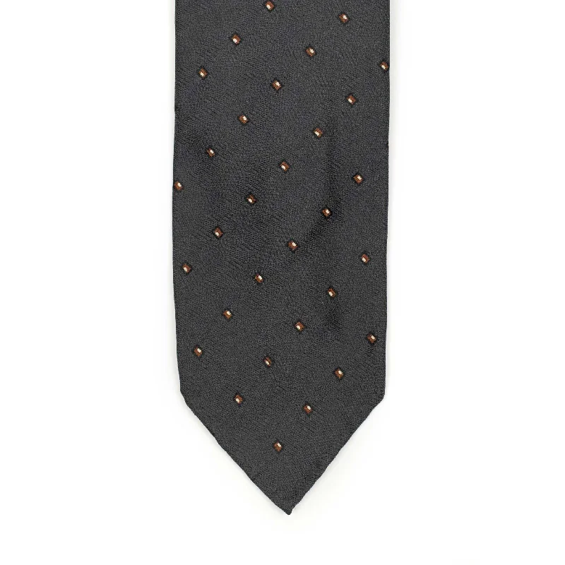 Unique silk tie for office professionals-Charcoal grey subtle herringbone silk tie, rust and white jacquard square dots